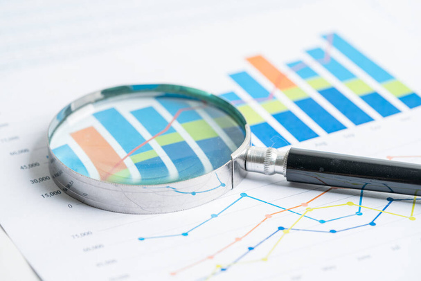 Magnifying glass on charts graphs paper. Financial development, Banking Account, Statistics, Investment Analytic research data economy, Stock exchange trading, Business office concept. - Photo, Image