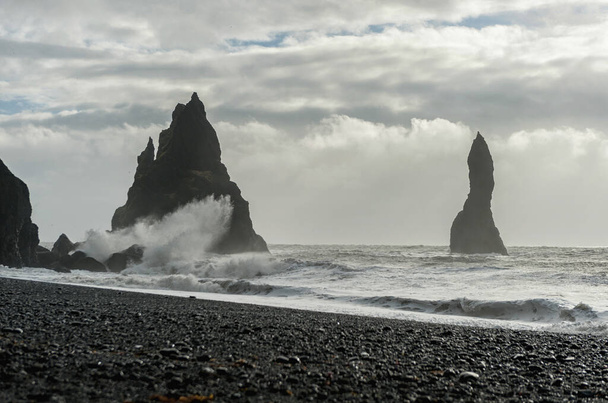 黒砂のビーチアイスランドのレイニスフィヤラ。水と海の波の岩のスプラッシュ - 写真・画像