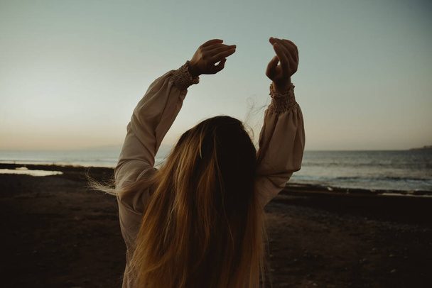 Girl on the beach with long hair, summer mood. Sunset, woman in a beautiful dress on vacation. - Φωτογραφία, εικόνα