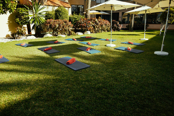 Outdoor yoga, pilates or stretching, many outdoor grass mats, sports and hobbies. - Fotó, kép