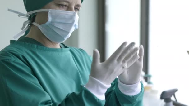 Doctor putting on surgical gloves , professional medical safety and hygiene for surgery and medical exam. - Filmati, video