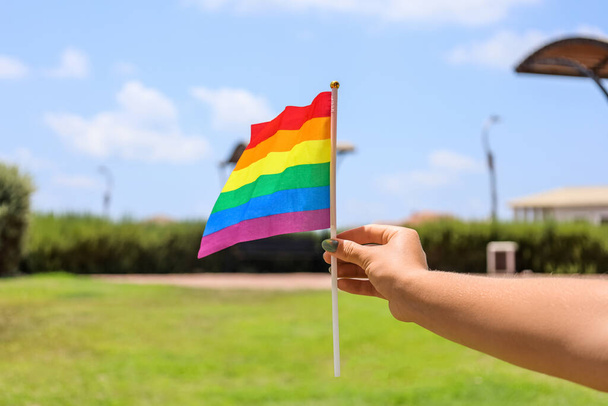 Woman with LGBT flag in park, closeup - Foto, Bild