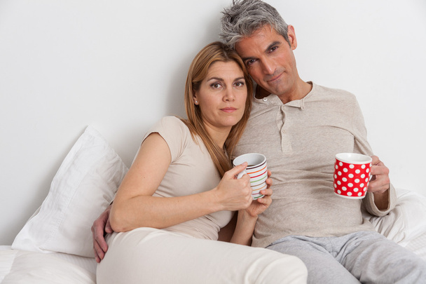 Couple drinking coffee in bed - Photo, Image
