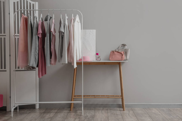 Rack with stylish female clothes in interior of room - Photo, image