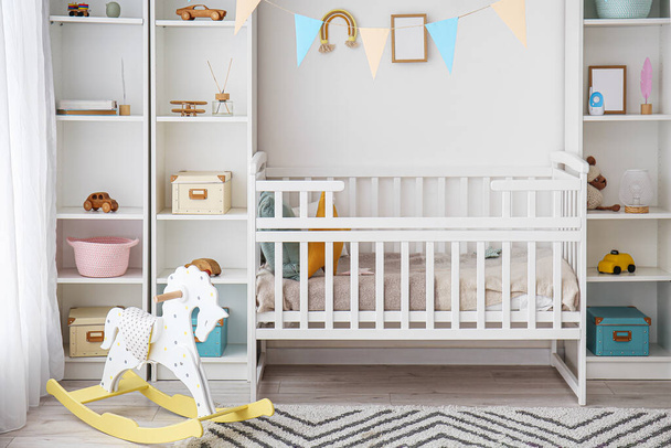 Stylish interior of children's room with baby bed - Fotoğraf, Görsel