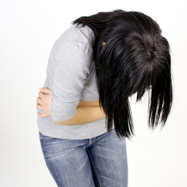Young woman feeling stomach sick isolated - Foto, immagini