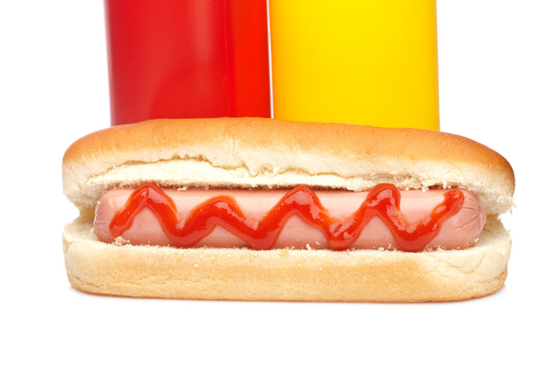 Hot dog with ketchup and mustard bottles - 写真・画像
