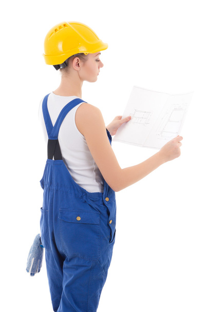вид ззаду на жінку-будівельника в блакитному костюмі, що тримає будівельний шк
 - Фото, зображення