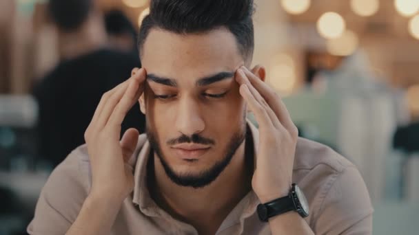 Indian Hispanic ethnic man suffer with headache sad depressed guy businessman has business problem frustrated with pain massage head dizzy unhappy male feel migraine anxiety stress trouble sickness - Video, Çekim
