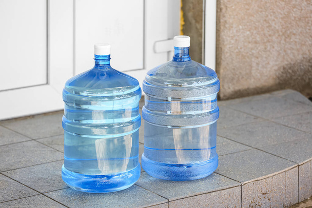 Bottles of clean water on step outdoors - Fotoğraf, Görsel