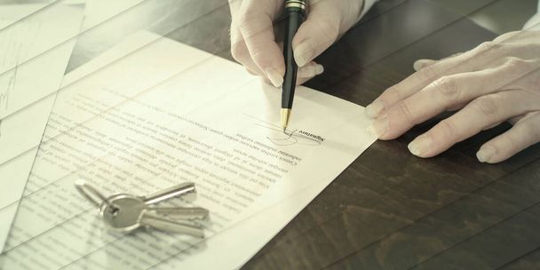 Woman signing a real estate contract on a desk, geometric pattern - Fotoğraf, Görsel