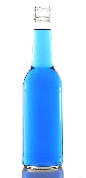 Colorful alcoholic beverage in glass bottle isolated on white - Photo, image