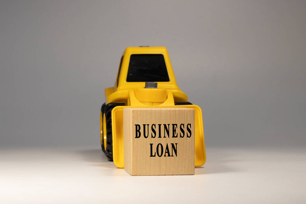 Business loan text. It is written on a wooden surface. The background is white - Foto, immagini