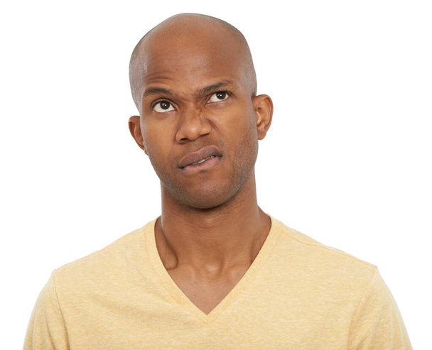 Feeling unimpressed. A young african-american man looking skeptical while isolated on a white background - Foto, imagen