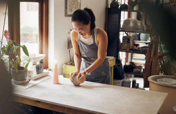Creative, small business and pottery girl working with clay for idea, inspiration and art process. Creativity, business owner and asian woman focused at artistic workspace in Tokyo, Japan. - Фото, изображение