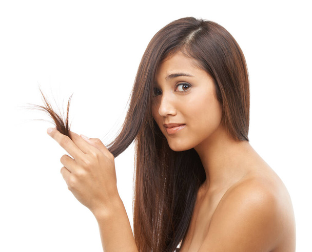 Split ends driving you crazy. Portrait of an attractive young woman with long and healthy hair - Photo, Image