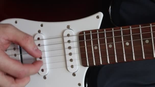 Man playing electric guitar. Close up of hands playing electric guitar - Video