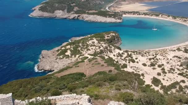 Aerial panorama view over the famous castle of Navarino located on the top of semicircular sandy beach and lagoon, Voidokilia in Messenia, Greece - Filmati, video