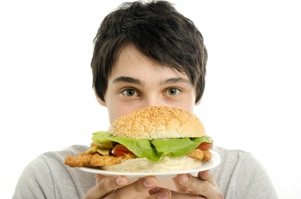 Man offering a big hamburger, fast food, take out for you - Foto, Imagem