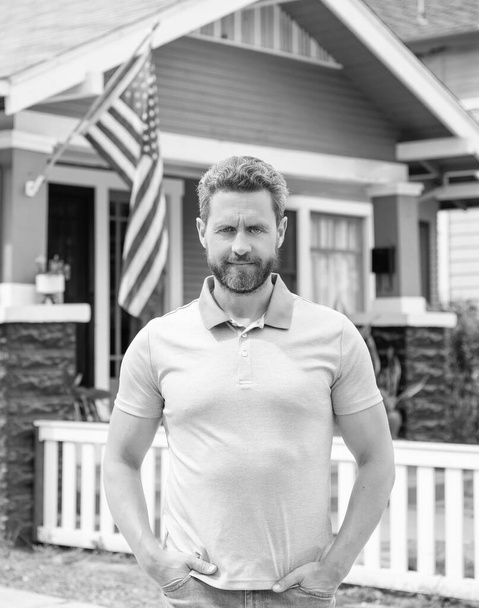 bearded man realtor selling or renting house with american flag, ownership. - Photo, Image
