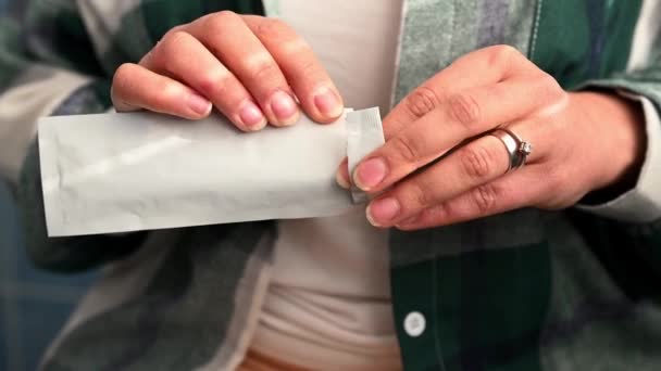 Cropped view of womans hands unpacking and removing home pregnancy test from package. Maternity and gynecology concept. Fertility. Womens health - Materiał filmowy, wideo