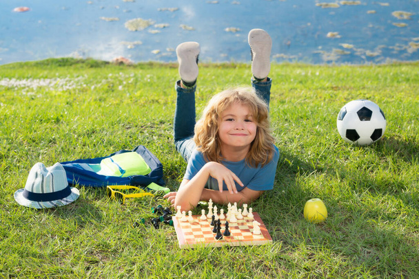 Chess game for kids. Child playing chess - Fotó, kép