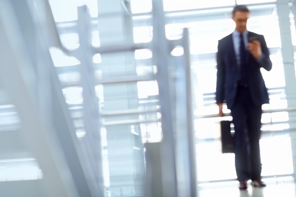Blurred, travel or business man with phone for invest strategy, finance growth or financial review. CEO, airport or manager with smartphone for planning, data analysis or economy data web research. - Photo, Image