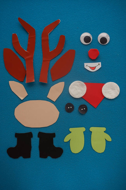 Christmas New Year Santa's deer handmade. Step by step photo instruction. DIY concept. Step 2-13. Preparation elements. Cut, draw - eyes, nose, antlers, mittens, boots, scarf. Top view, Flat lay - Foto, afbeelding