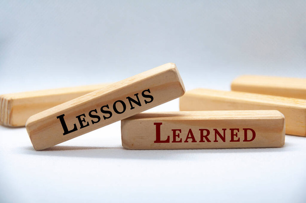 Lessons learned text on wooden blocks on white cover background. - Foto, Imagen