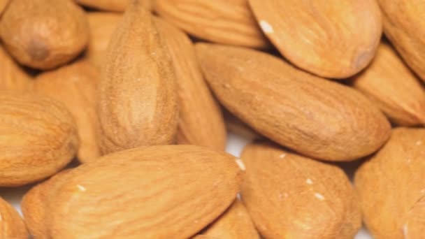 Macro video of almonds in shell rotating. Concept of healthy eating and raw food. Vegan food - Felvétel, videó