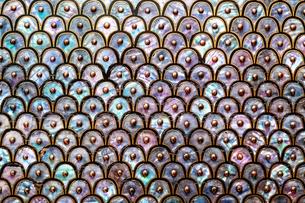 Abstract background of mother of pearl. Circular and overlapping antique design of nacre or abalone shell, with black and gold design and studs. - Foto, imagen