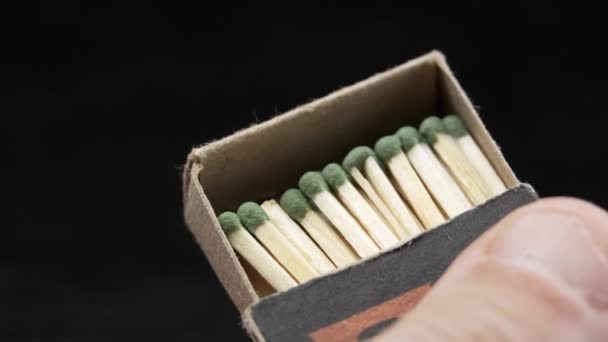 Box of matches in his hands. Box with close-up wooden matches in hands of man. He pushes out part and shows lot of matches. - Footage, Video