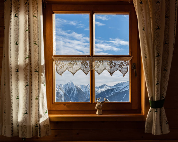 Morning view of the mountains through a window in a mountain hut, Austria. High quality photo - Photo, Image