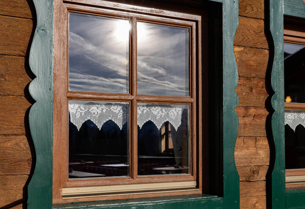 Mountain hut window reflecting dramatic cloudy sky, Austria. High quality photo - Foto, immagini