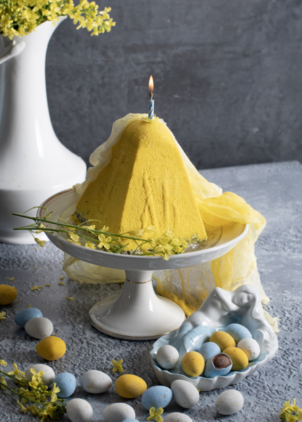 Traditional Easter Orthodox curd cake with yellow flowers on a grey table, High quality photo - Photo, Image