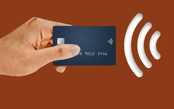 A hand holds a credit card next to a NFC near field communication or wi-fi  icon in this 3-d illustration about credit card security and convenience. - Photo, Image