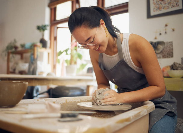 Clay, happy or creative woman in workshop working on an artistic cup or mug mold in small business. Pottery project, Asian girl or Japanese designer manufacturing handicraft products as entrepreneur. - 写真・画像