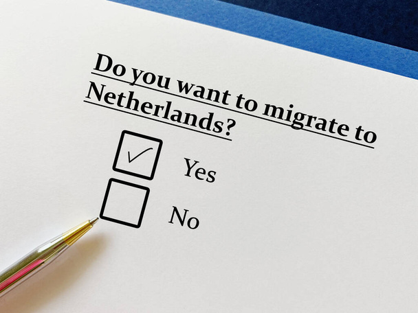 A person is answering question about moving to a new place. He wants to migrate to netherlands. - Foto, Imagem