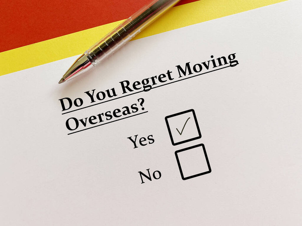 A person is answering question about moving to a new place. He is regret moving overseas. - Foto, Imagem