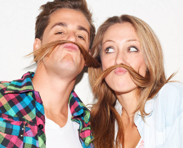 Having fun. Young hipster couple pretending to have moustaches - Foto, immagini