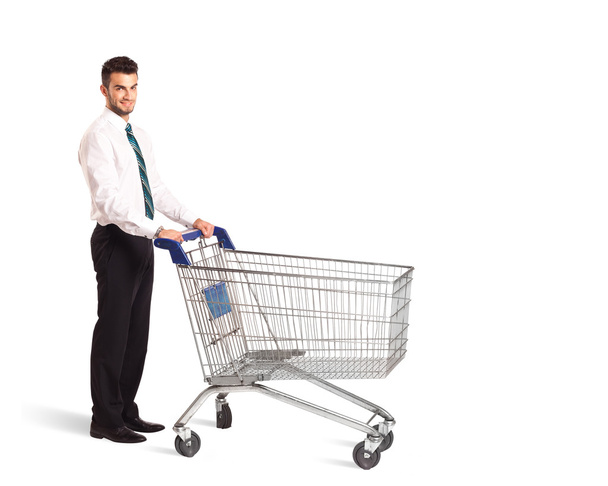 Businessman with shopping cart - Фото, изображение