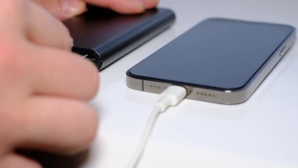 Close-up of charging a smartphone from a Power Bank. Phone charging port. We turn on the charging of the phone by wire. - Filmati, video