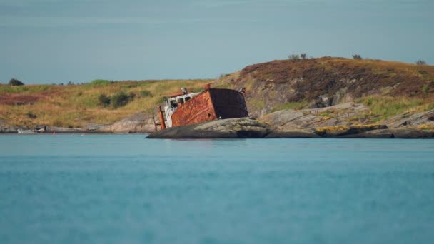 A rusty shipwreck on the rocky shore of the Atlantic. Stark northern landscape in the background. High-quality 4k footage - Filmmaterial, Video