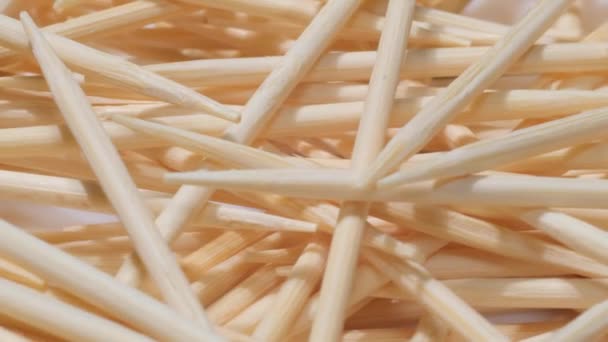 A pile of white wooden toothpicks. Macro video. Texture. Movement in a circle. - Video