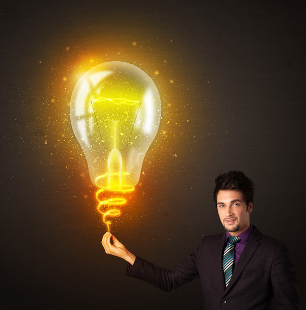 Businessman with an idea bulb - Фото, зображення