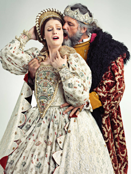 Medieval king, queen and violence in studio for drama, danger and together with renaissance clothes. Ancient royal couple, surprise and shock with distress, crying and actor with vintage fashion. - Foto, Imagem