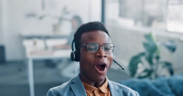 Black businessman, call center and winner celebrating victory, deal or sale in telemarketing at office desk. Happy African American man consultant in celebration for online promotion or achievement. - Felvétel, videó
