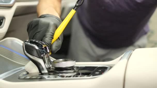 Washing the car interior with a soft brush and foam. A car service worker wipes the instrument panel with a special brush. - Footage, Video