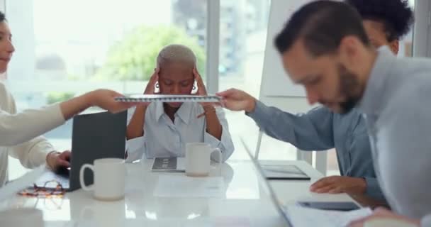 Stress, headache and professional black woman in a meeting with her team in the conference room. Migraine, burnout and stressed African business manager working with her colleagues in the office - Materiał filmowy, wideo