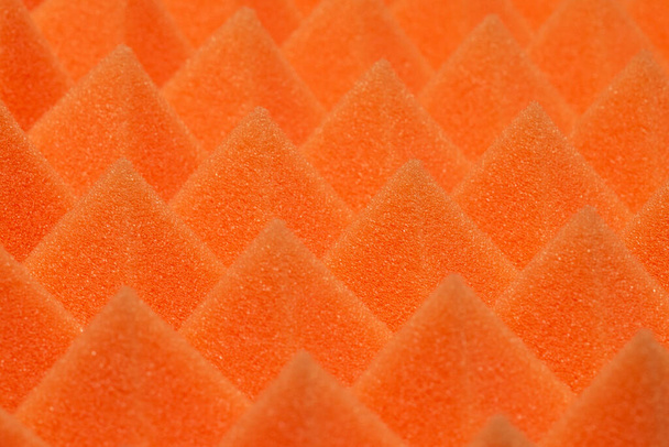 Triangular Orange Noise Dampening Foam Background Texture. Soundproofing material - Foto, afbeelding